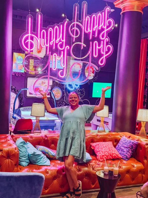 Joy In Front Of A Sign That Says Happy Happy Joy Joy (1)